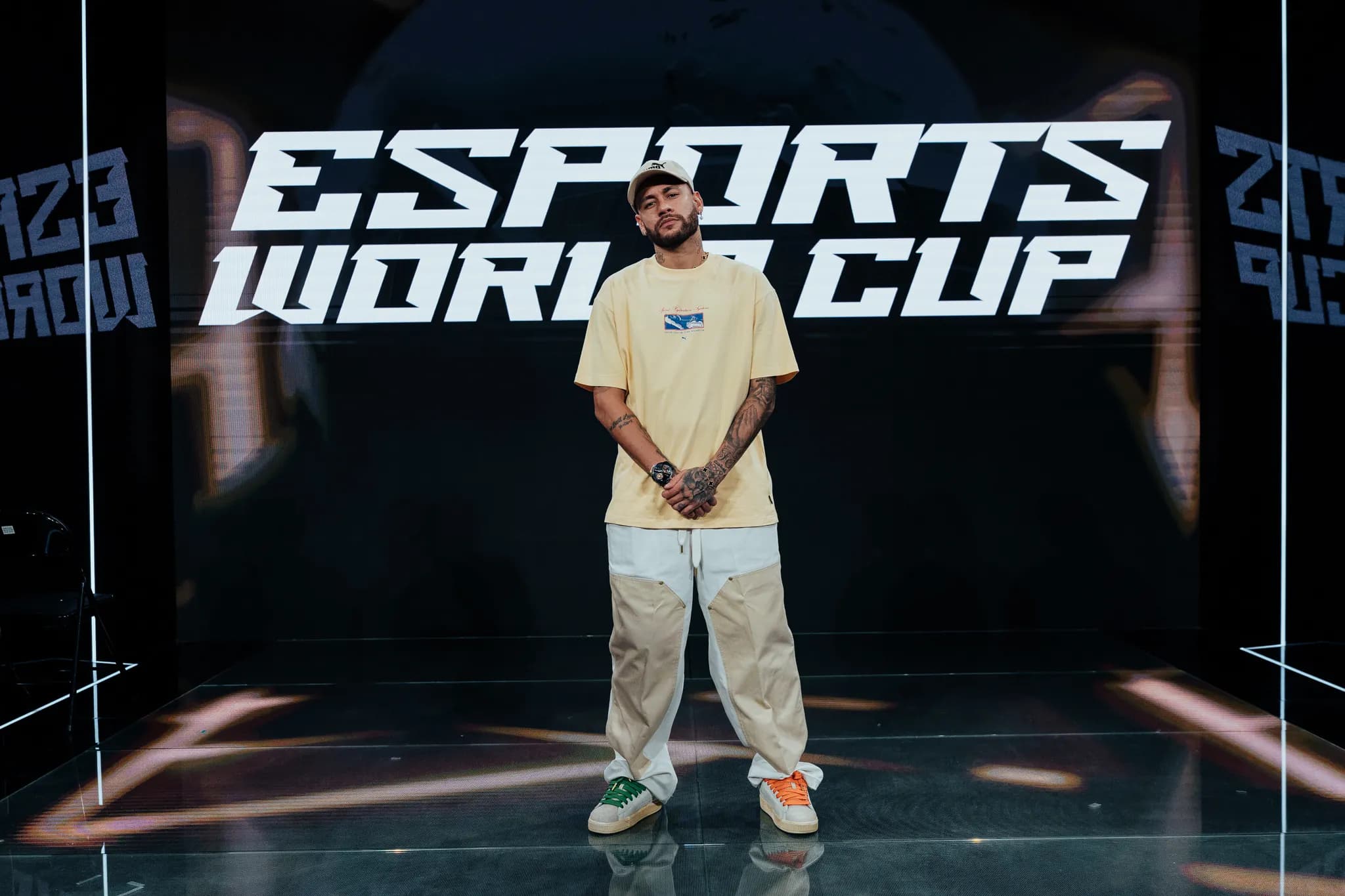 A creator standing in front of an esports stage